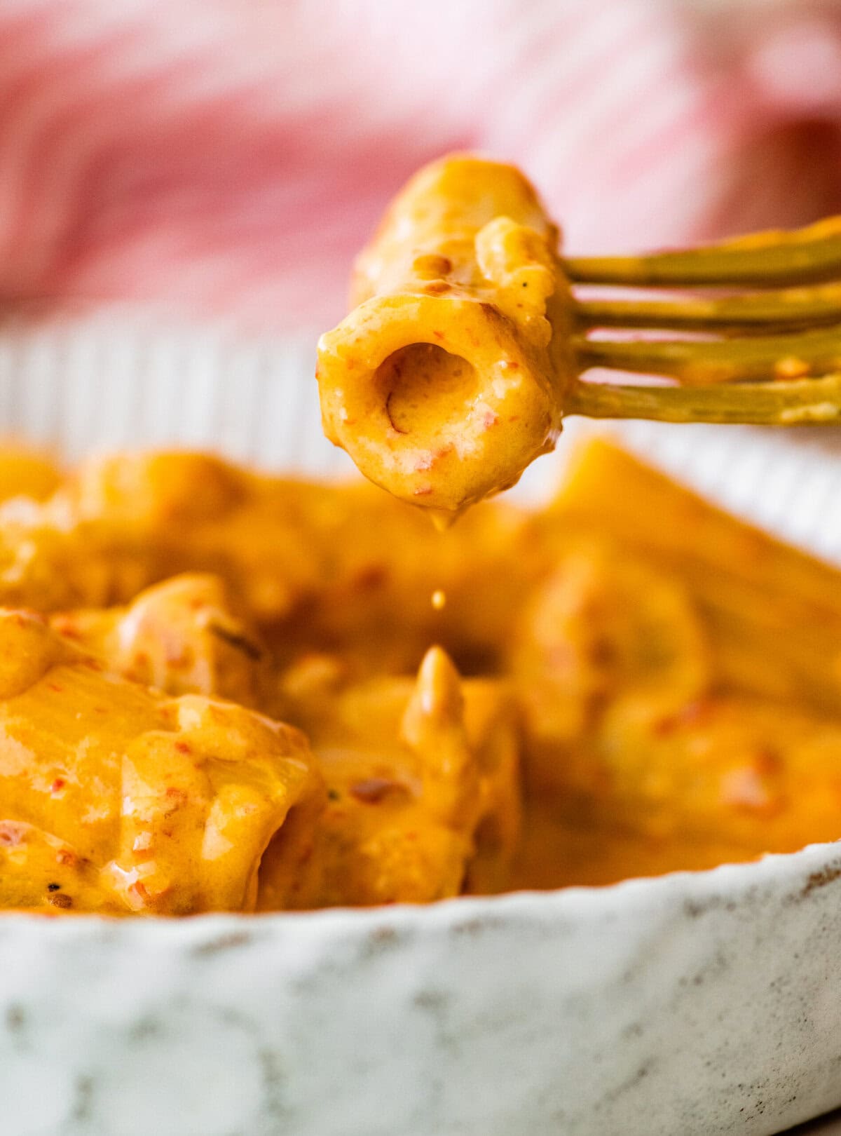 creamy nduja pasta in a bowl with a fork.