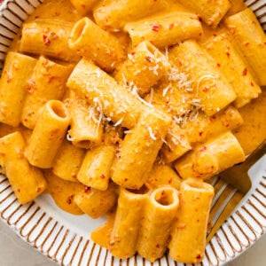 creamy nduja pasta in a bowl with a fork.