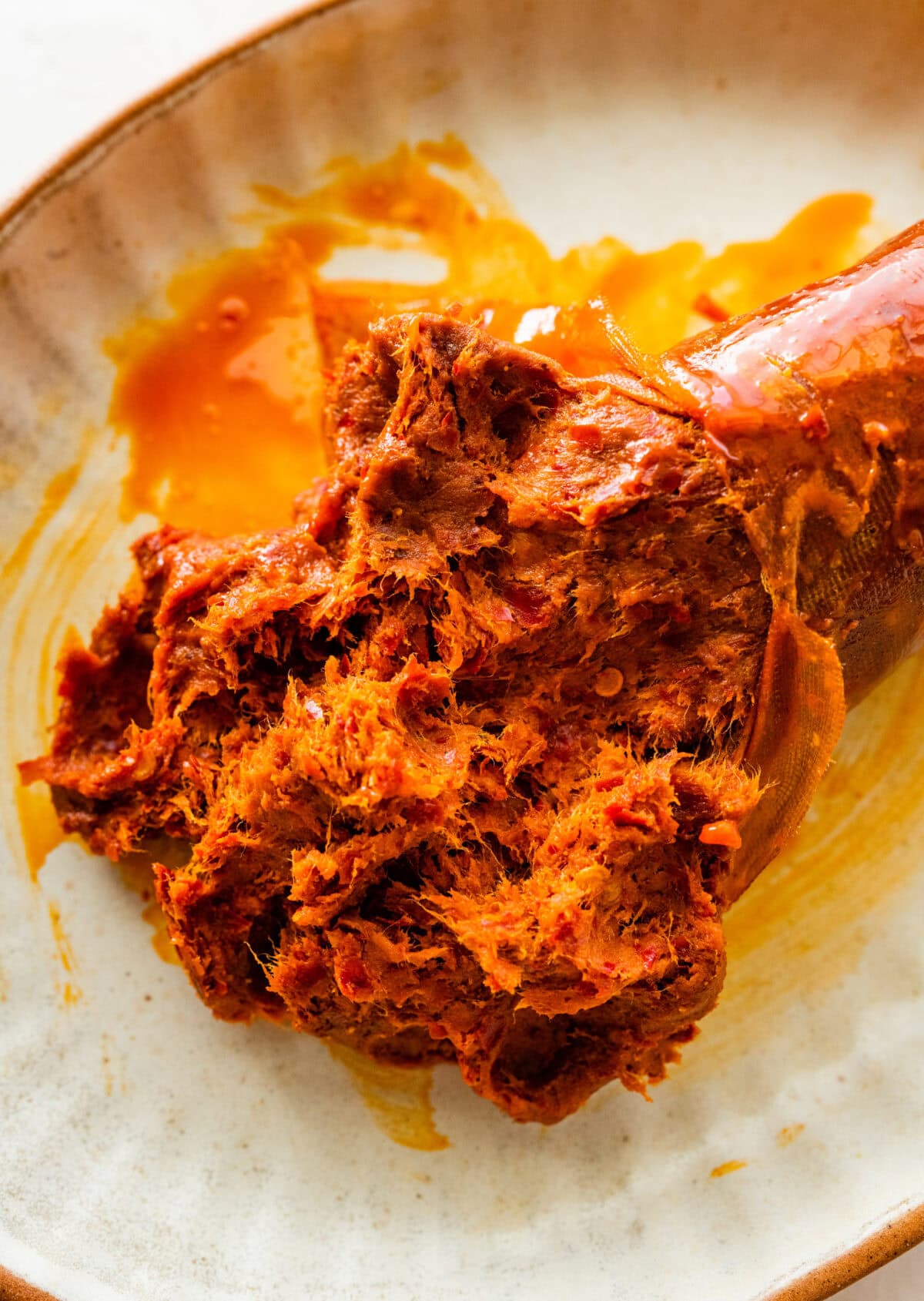 nduja spicy sausage spread out on a plate.