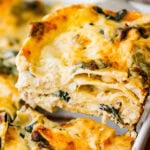 a slice of white chicken lasagna lifted from the baking pan.