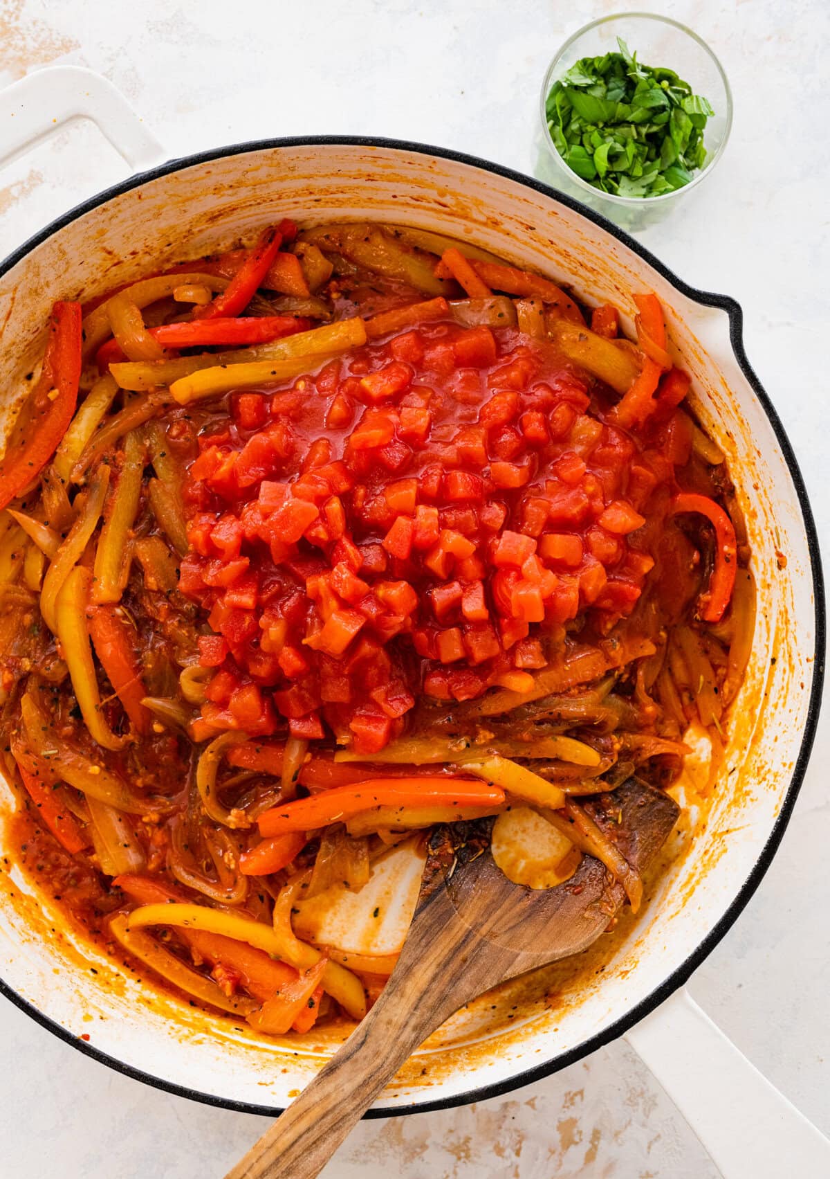 add the tomatoes to the cooked onions and peppers.