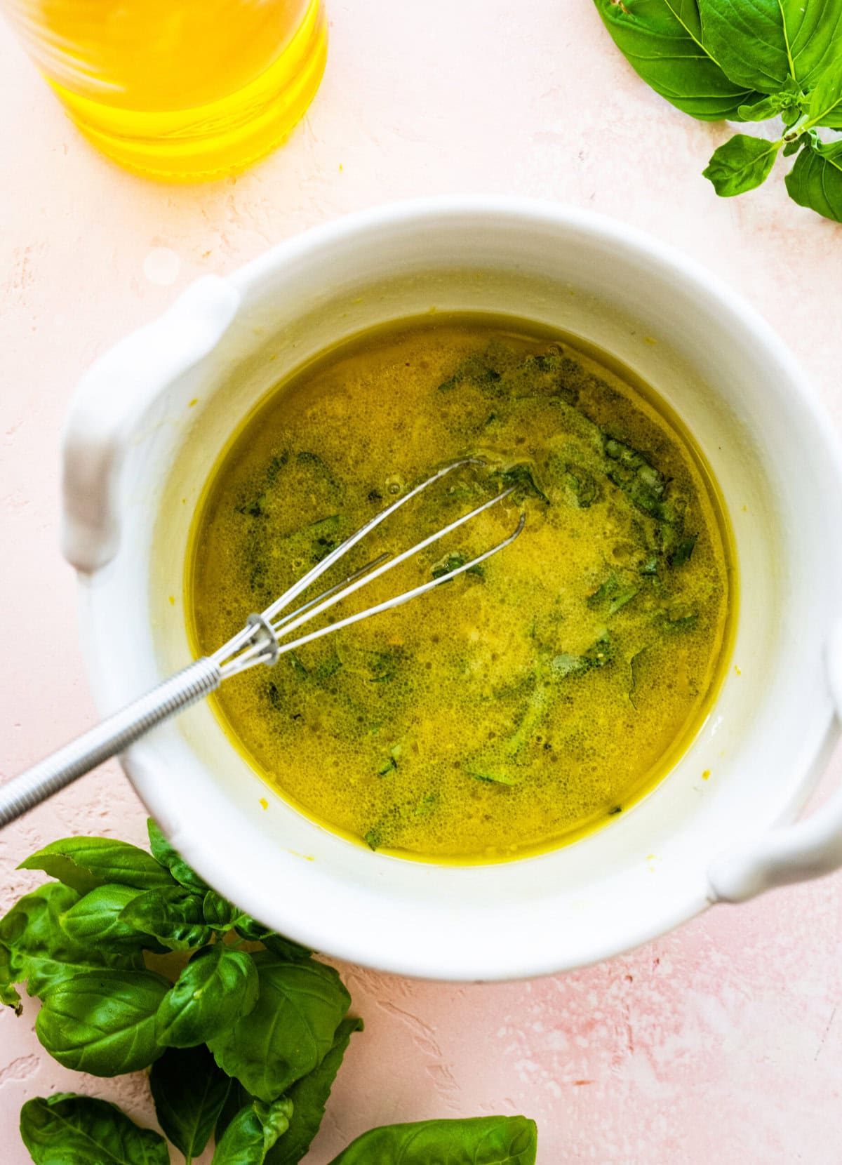 Mixed dressing with a whisk in the bowl.