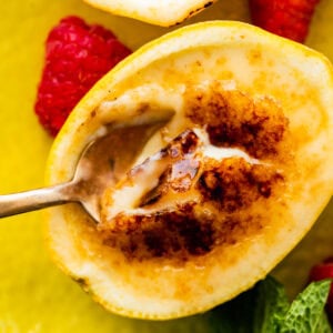a bite with the spoon of the creamy lemon posset and brulee toppin.
