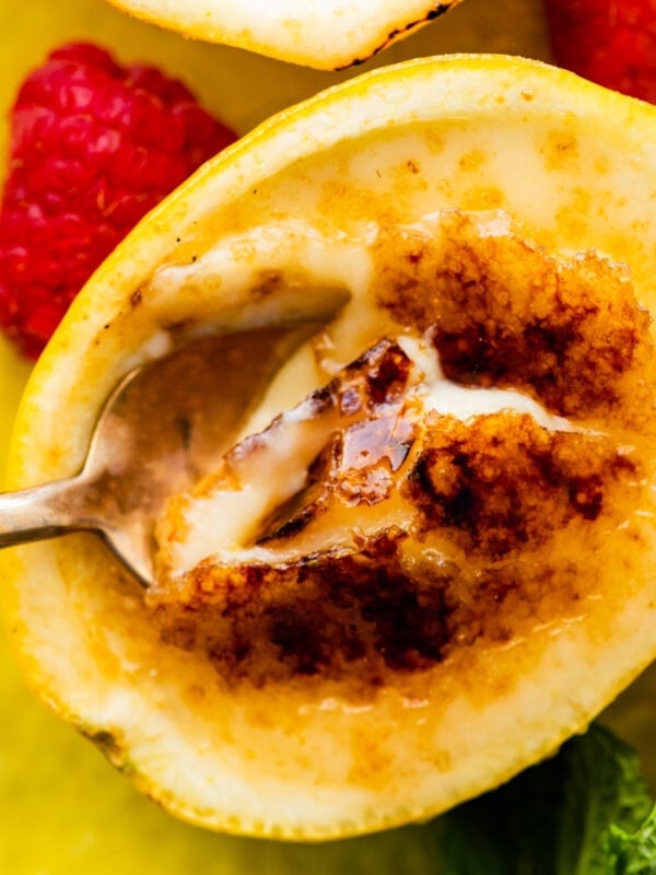a bite with the spoon of the creamy lemon posset and brulee toppin.