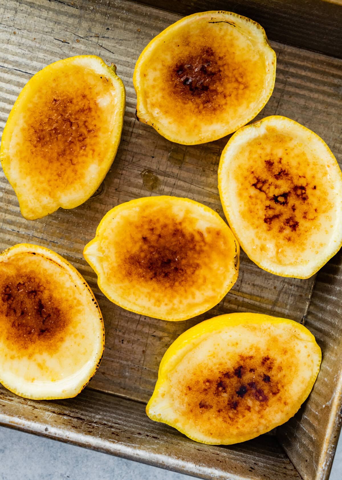 lemon posset with brulee topping on a cookie sheet.