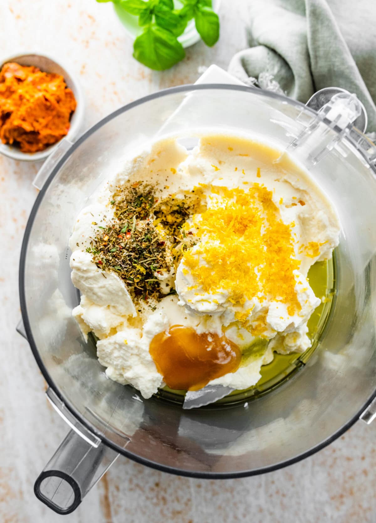 all the ingredients for the whipped ricotta in a food processor.