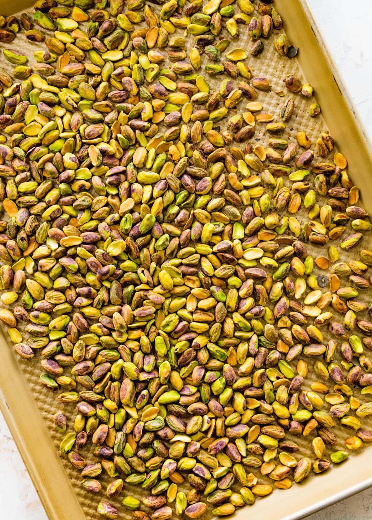 Roasting the pistachios before pulsing them.