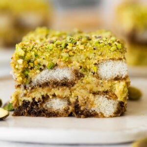 slice of pistachio tiramisu on a plate showing the layers.