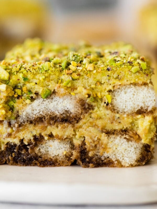 slice of pistachio tiramisu on a plate showing the layers.