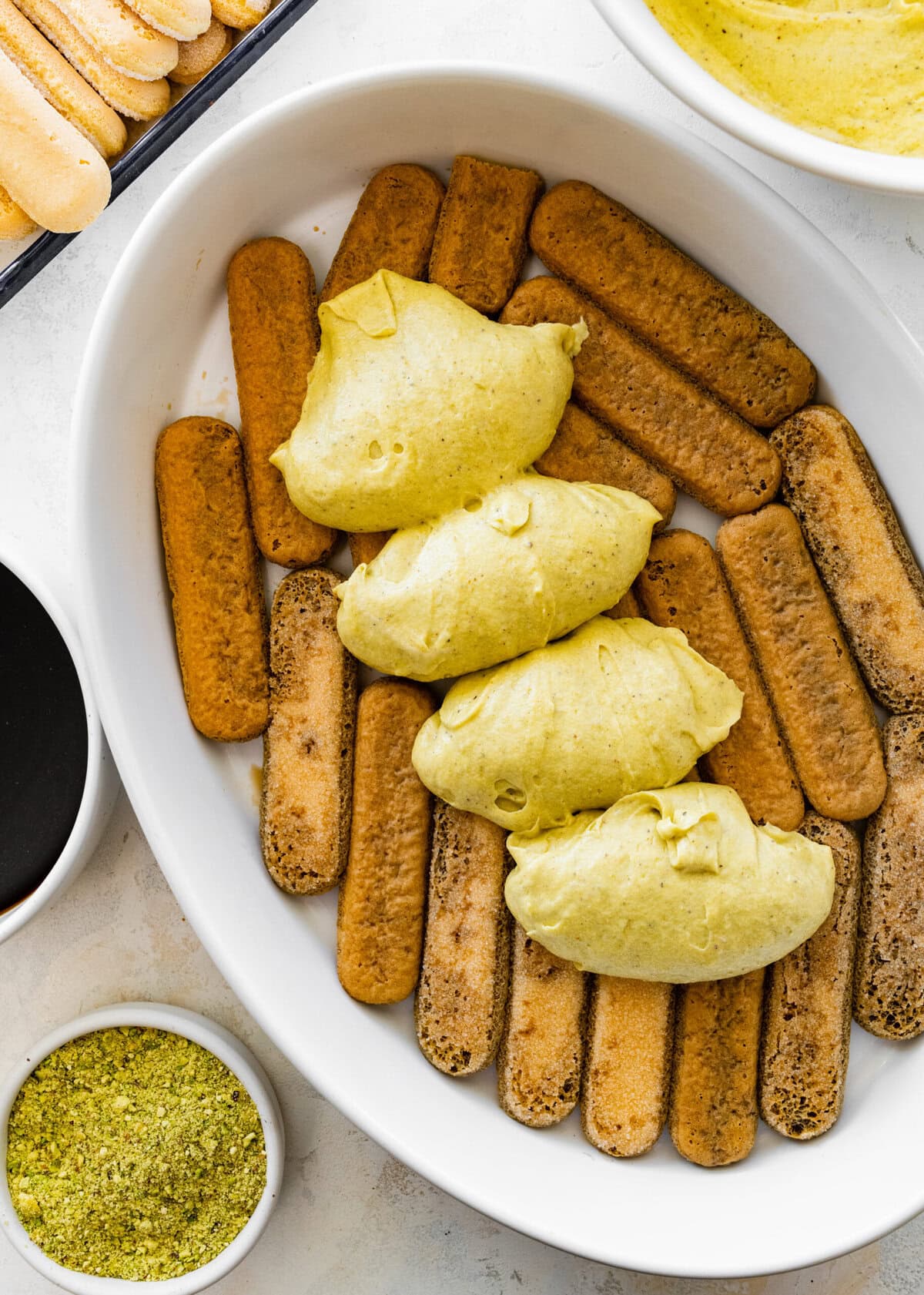 dip the ladyfingers in coffee and set in a large baking dish.