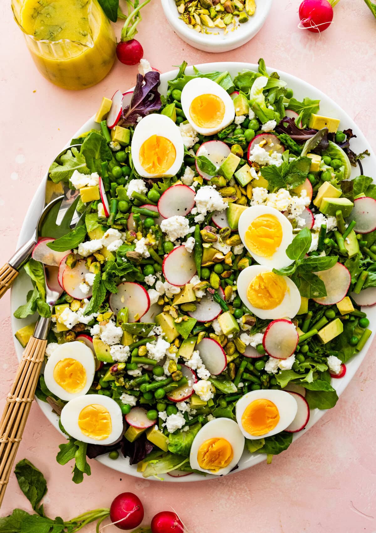 top the spring salad with radishes and the rest of the salad ingredients. Add hardboiled eggs on top if desired.