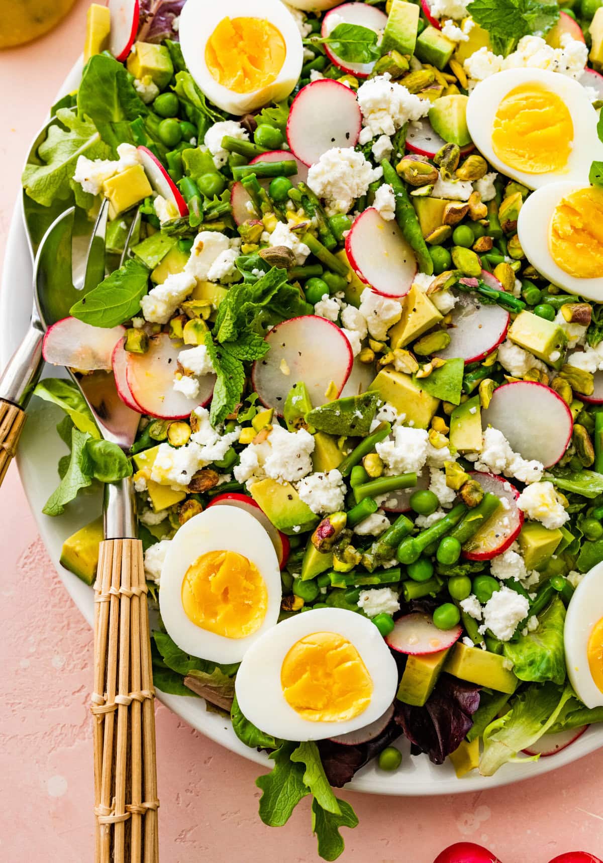 top the spring salad with radishes and the rest of the slaad ingredients. Add hardboiled eggs on top if desired.