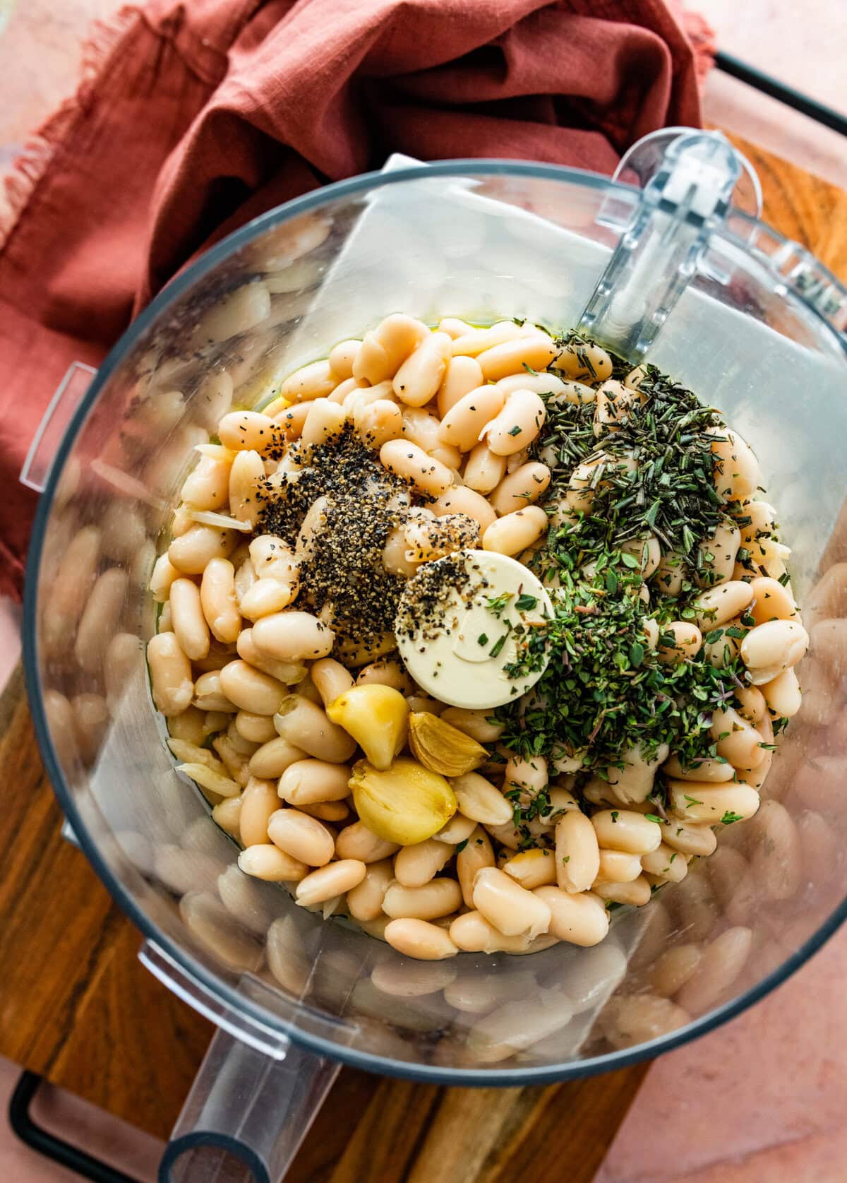 all ingredients for the white bean dip in a food processor ready to blend.