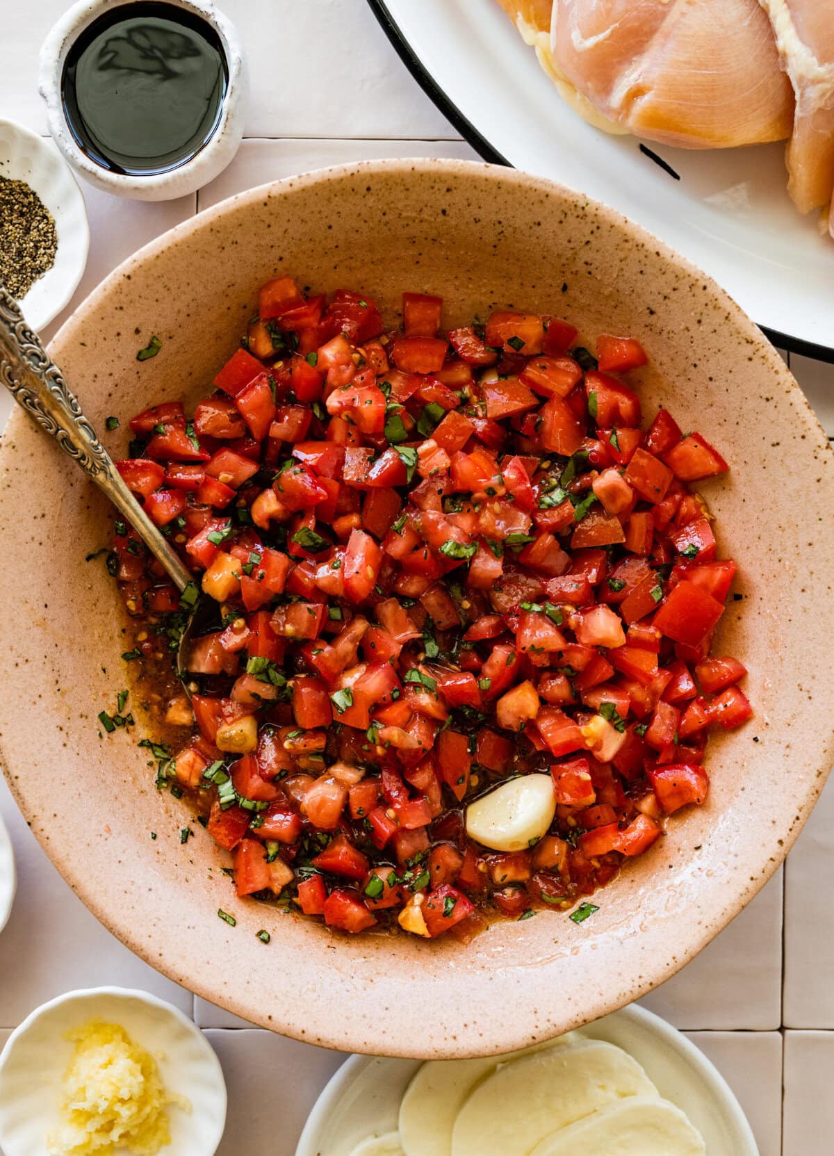 A bowl of tomatoes, garlic for the bruschetta topping.