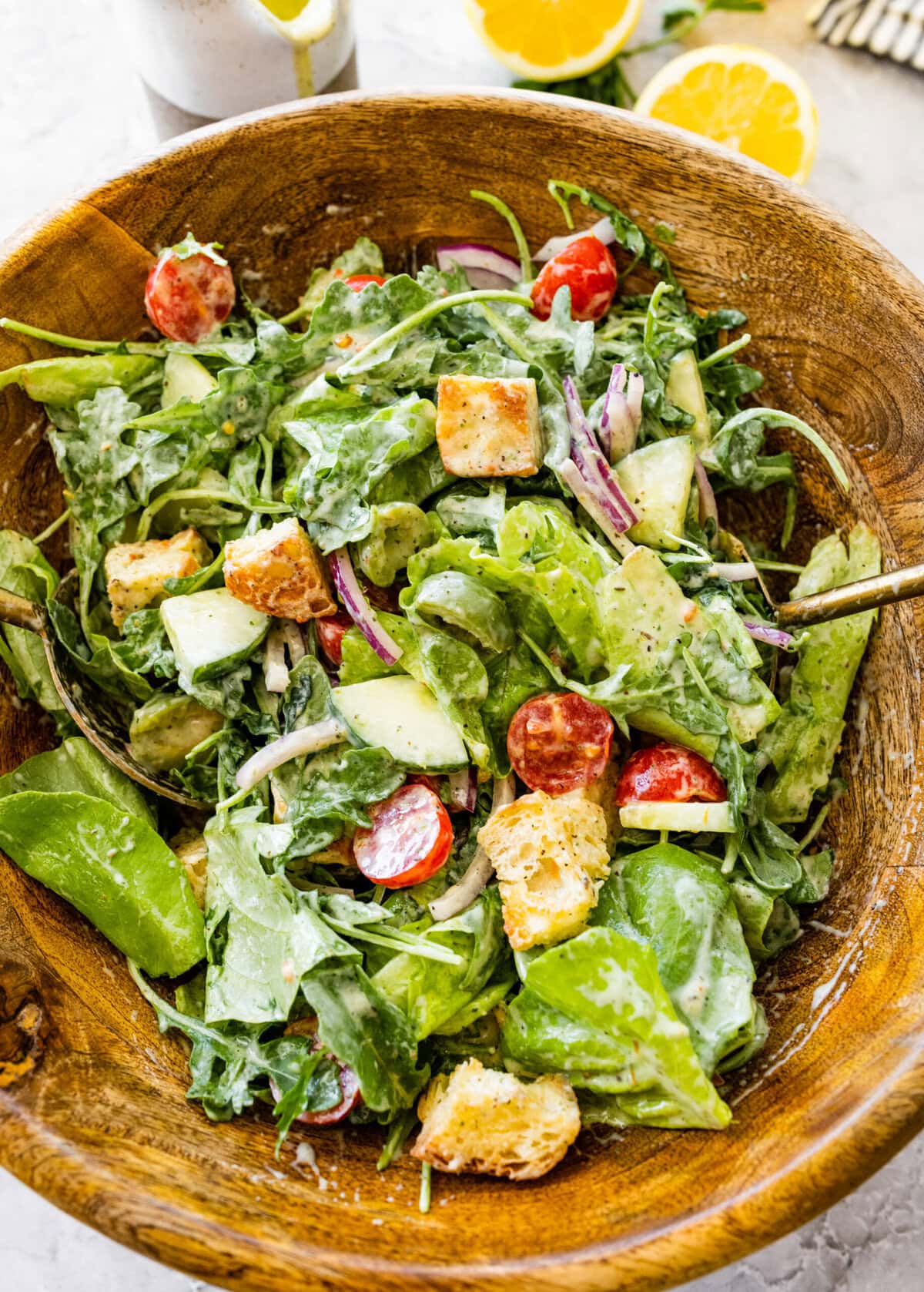 Tossed salad in a wooden bowl.
