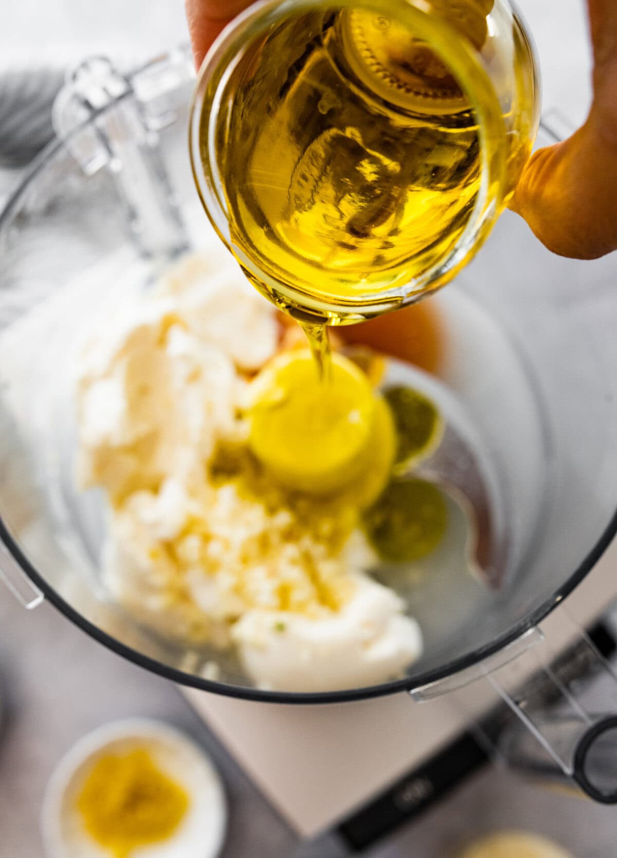 adding oil in a blender for the salad dressing.