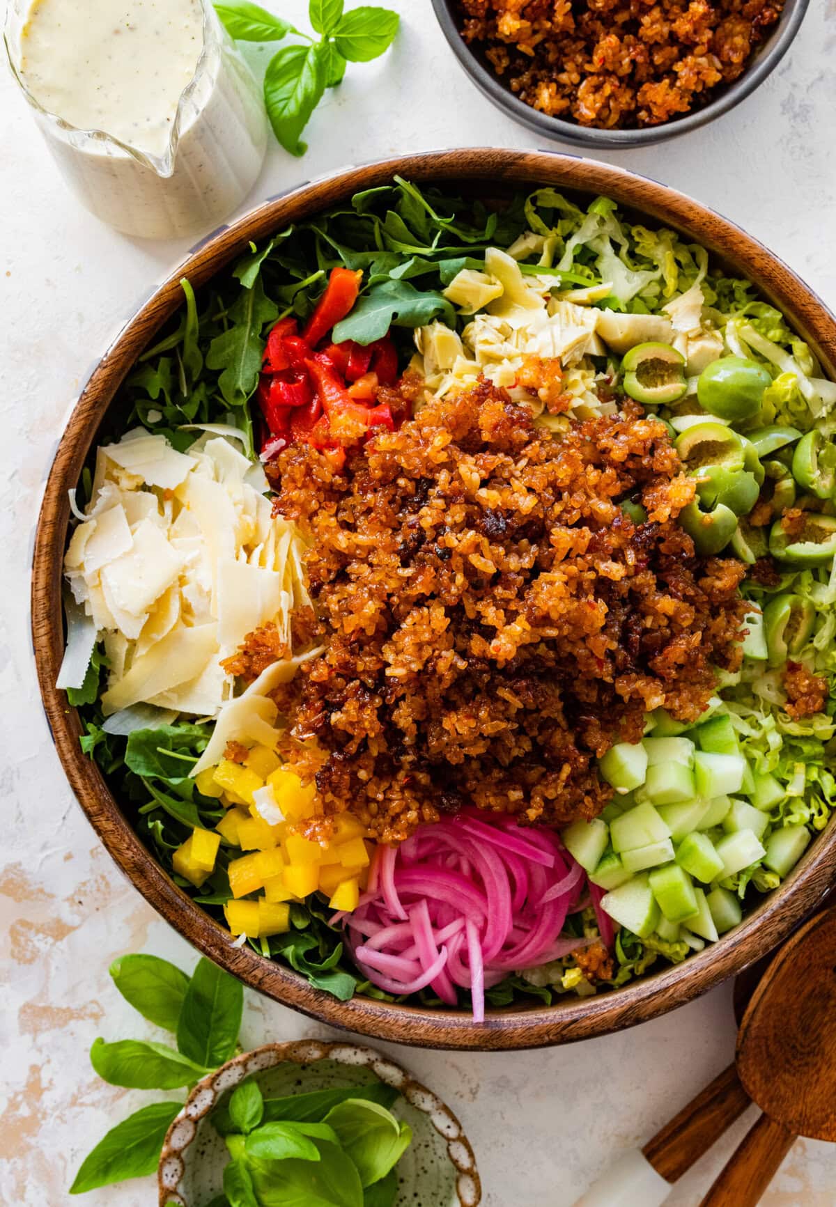 A bowl of salad with meat, vegetables and dressing