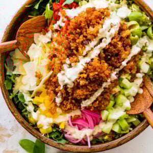 A bowl filled with crispy rice salad and dressing.