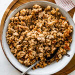 homemade Italian sausage cooked and crispy in a bowl with a spoon.