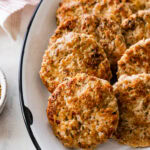 cooked homemade Italian sausage patties on a white plate.