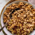 homemade Italian sausage cooked and crispy in a bowl with a spoon.
