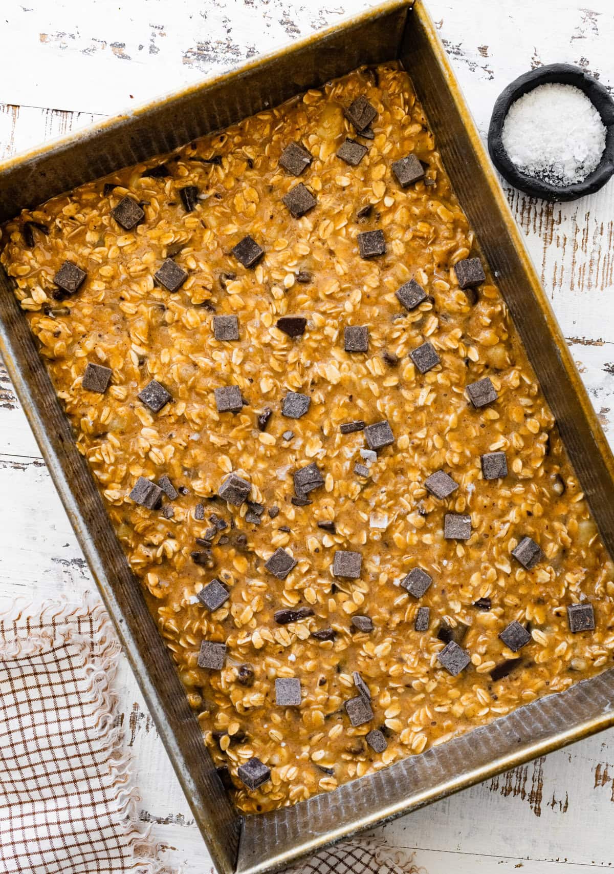 An oatmeal banana bars with chocolate chips in a baking pan.