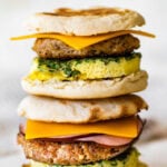 A stack of breakfast sandwiches on a white plate.