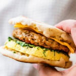 A tray of breakfast sandwiches with ham, cheese and eggs.
