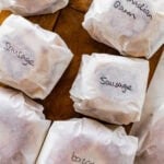 A bag of labeled frozen breakfast sandwiches sitting on top of a counter.
