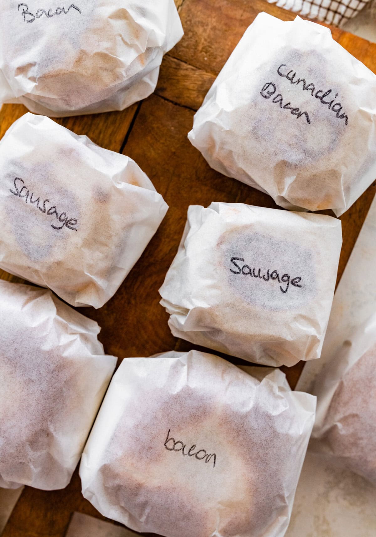 A bag of labeled frozen breakfast sandwiches sitting on top of a counter.