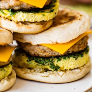A stack of breakfast sandwiches on a plate.