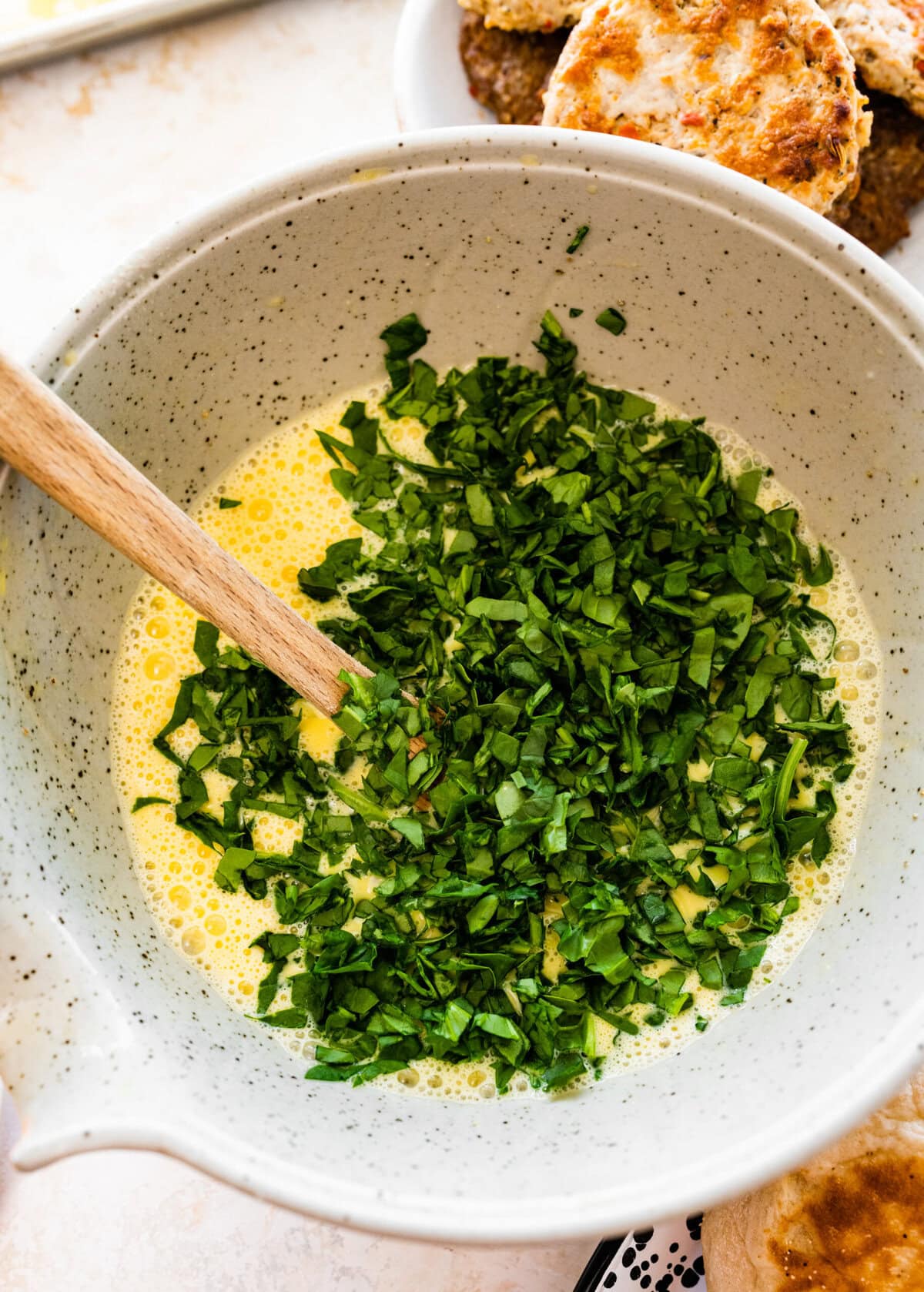 A bowl filled with chopped spinach and eggs.