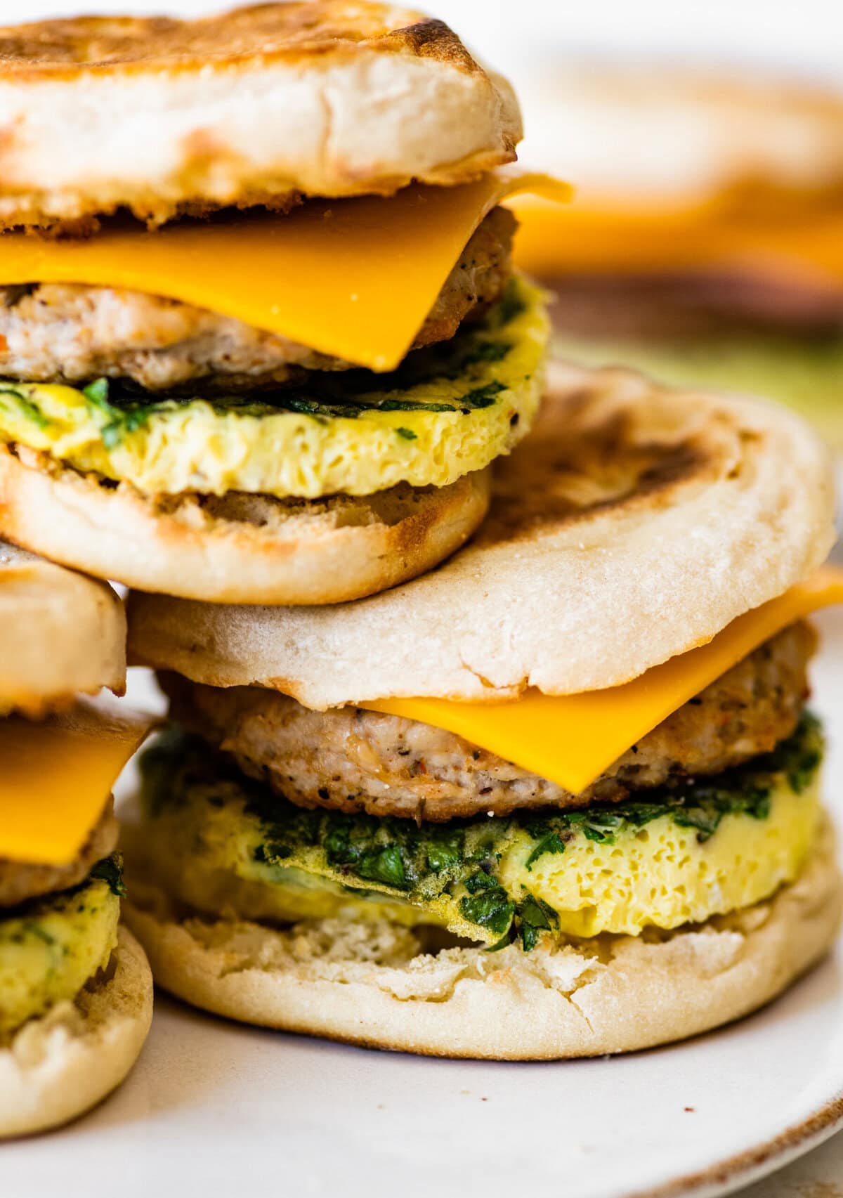 A stack of breakfast sandwiches with cheese and eggs.