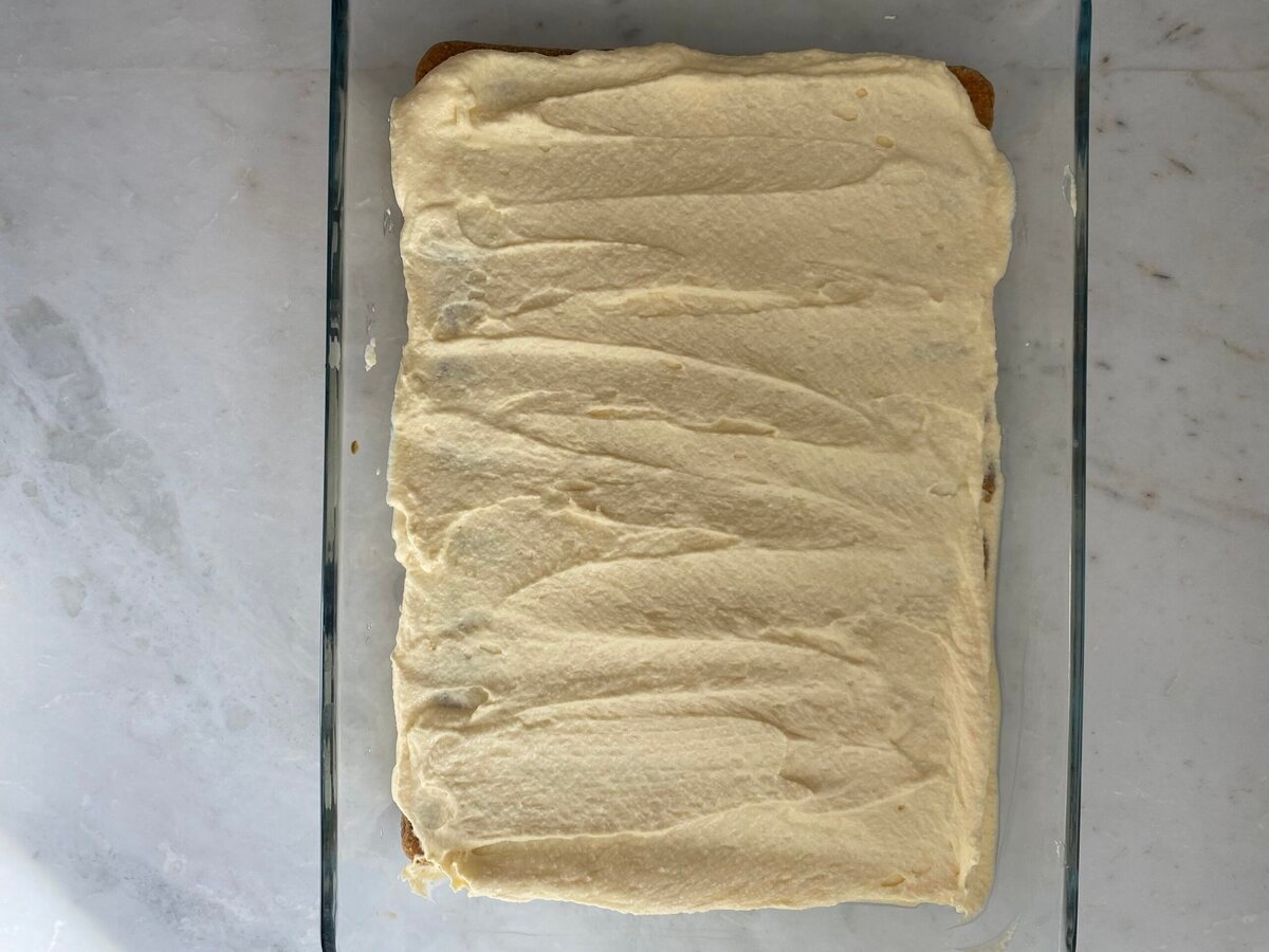 Mascarpone spread out on top of the lady fingers.