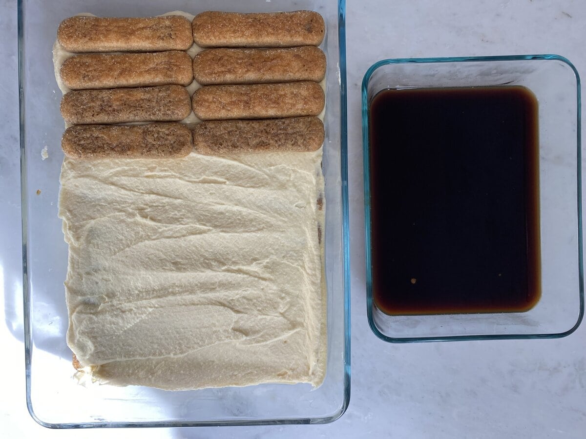 Adding another layer of lady fingers on top of the mascarpone.