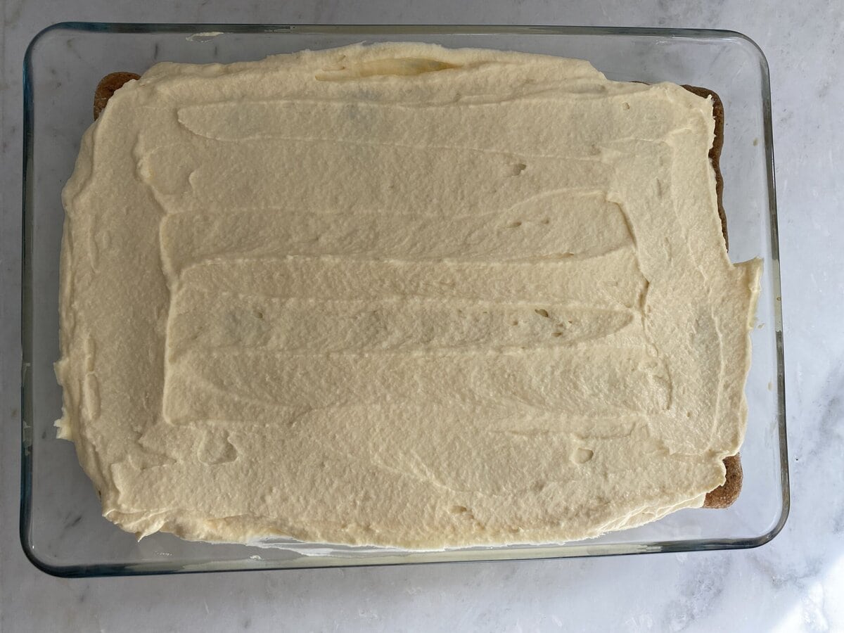 Last layer of mascarpone mixture spread over the top of the lady fingers.