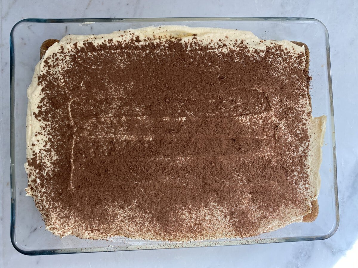 Finished tiramisu sprinkled with cocoa powder.