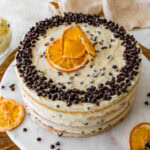 Finished cannoli cake with chocolate chips and orange slices.
