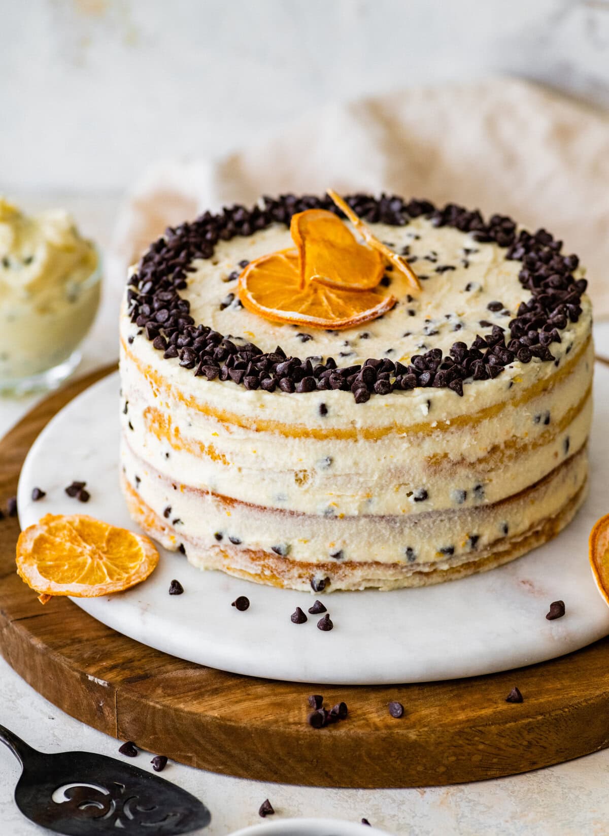Finished cannoli cake with chocolate chips and orange slices.