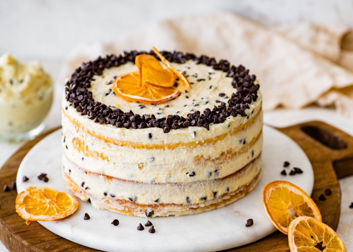 Finished cannoli cake with chocolate chips and orange slices.