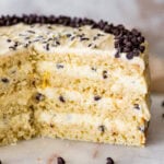 Cannoli cake with chocolate chips slices cut out to see the interior slices.