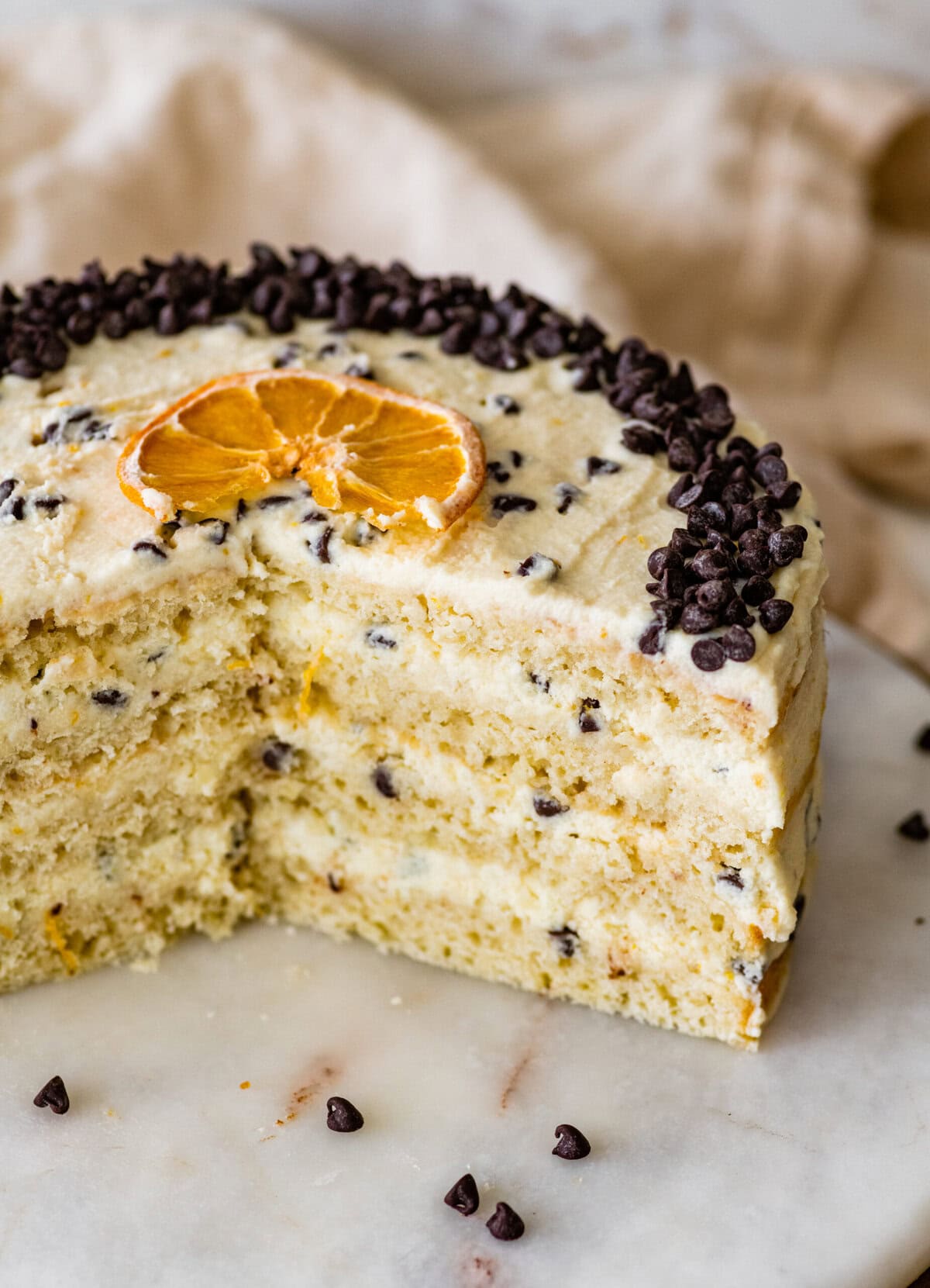 Cannoli cake with chocolate chips slices cut out to see the interior slices.