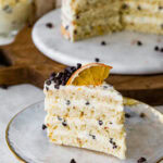 A slice of cannoli cake on a plate with a fork.