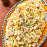 A Italian serving plate of pasta with cream salmon and cheese.