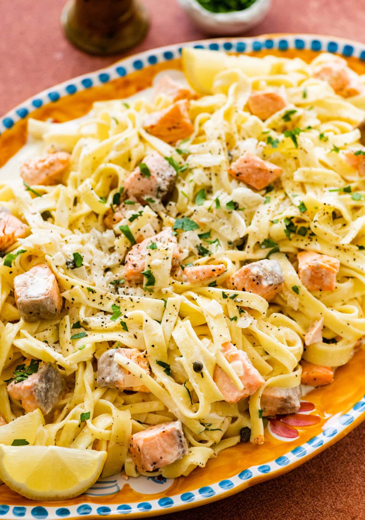 A Italian serving plate of pasta with cream salmon and cheese.