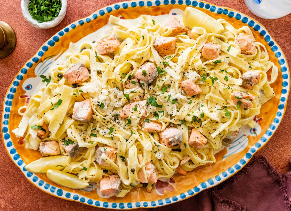 A Italian serving plate of pasta with cream salmon and cheese.