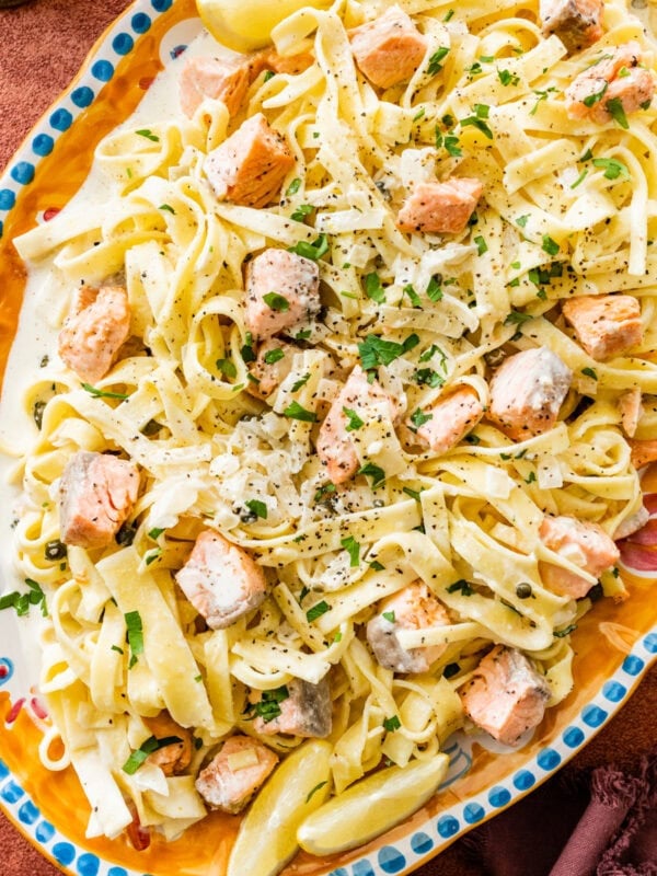 A Italian serving plate of pasta with cream salmon and cheese.
