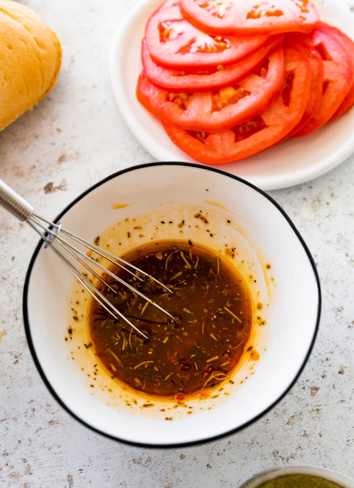 whisk in a bowl for the vinaigrette for the sub sandwiches.