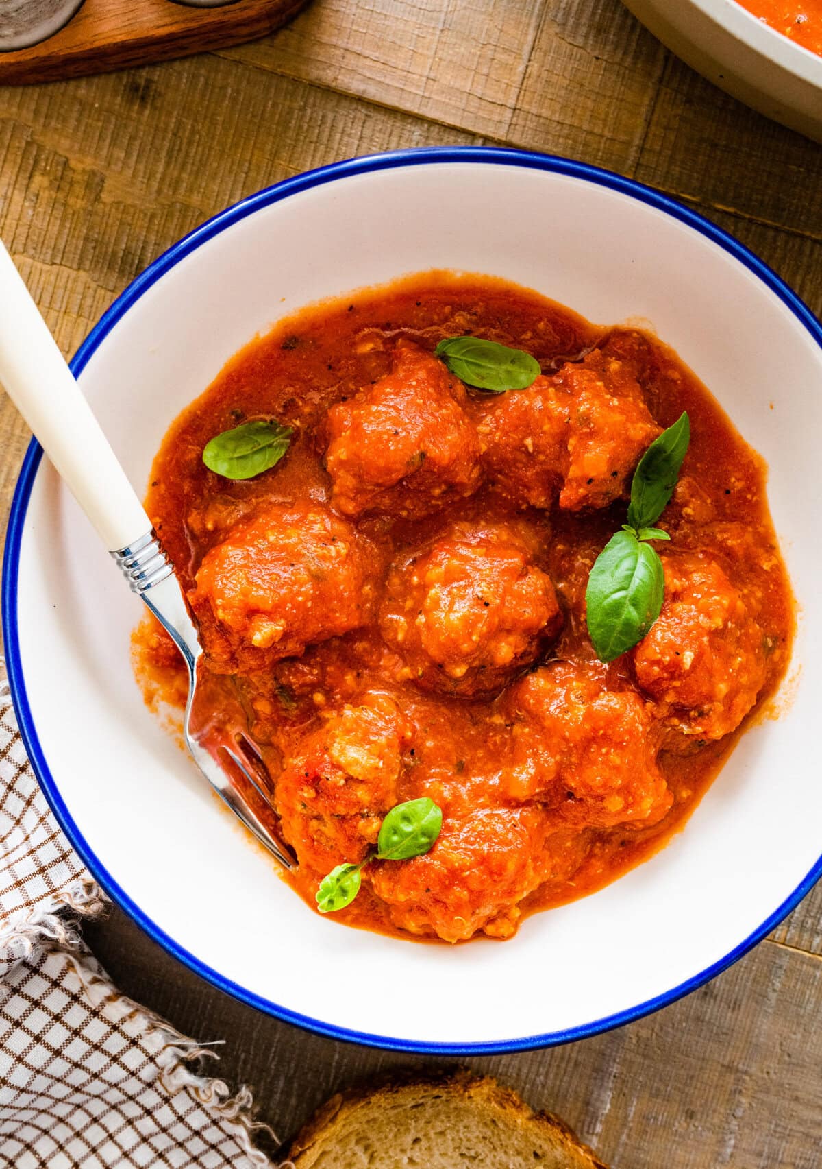 A bowl of Italian ricotta meatballs in tomato sauce.