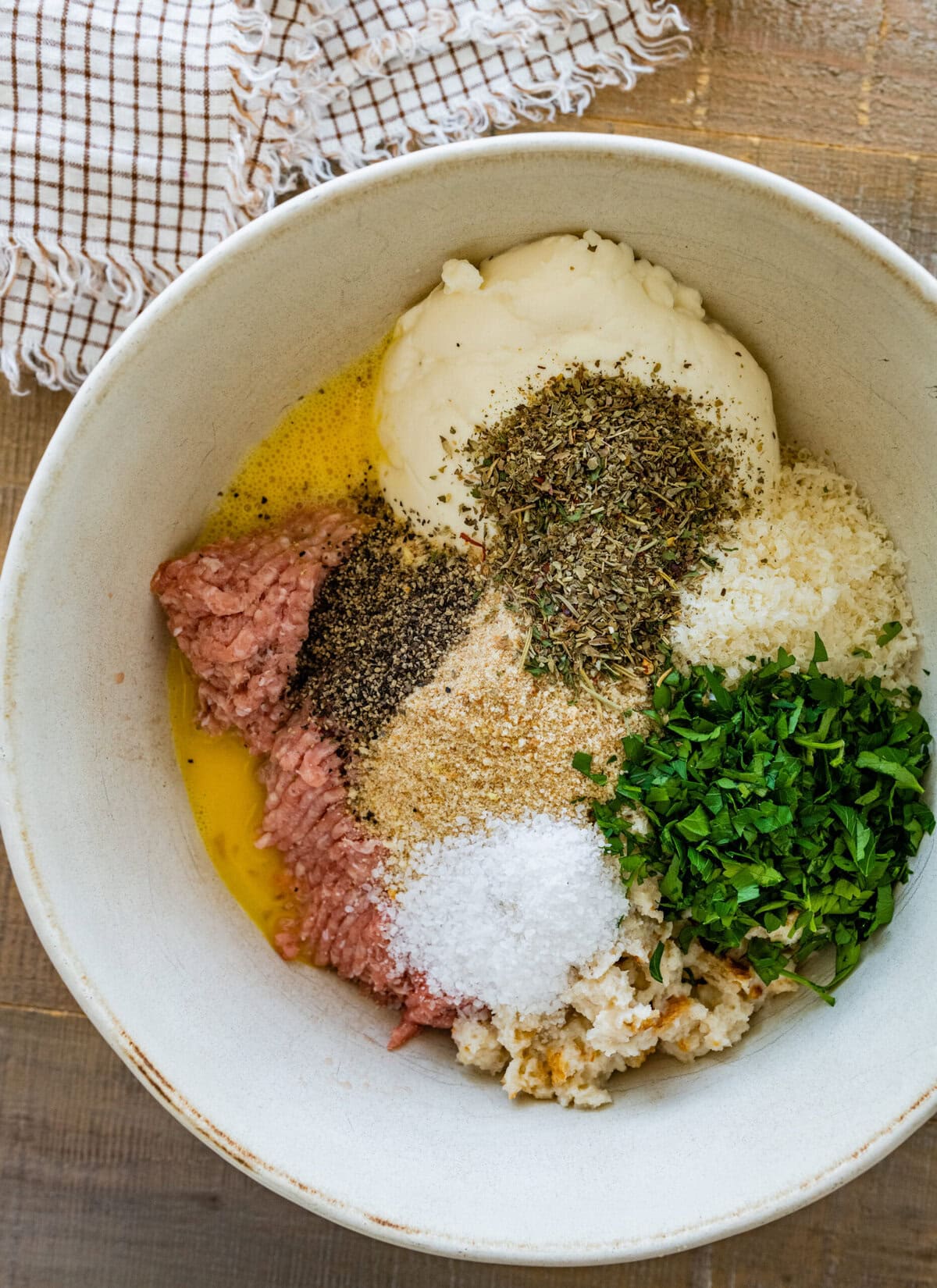 Ingredients for meatballs in a bowl.